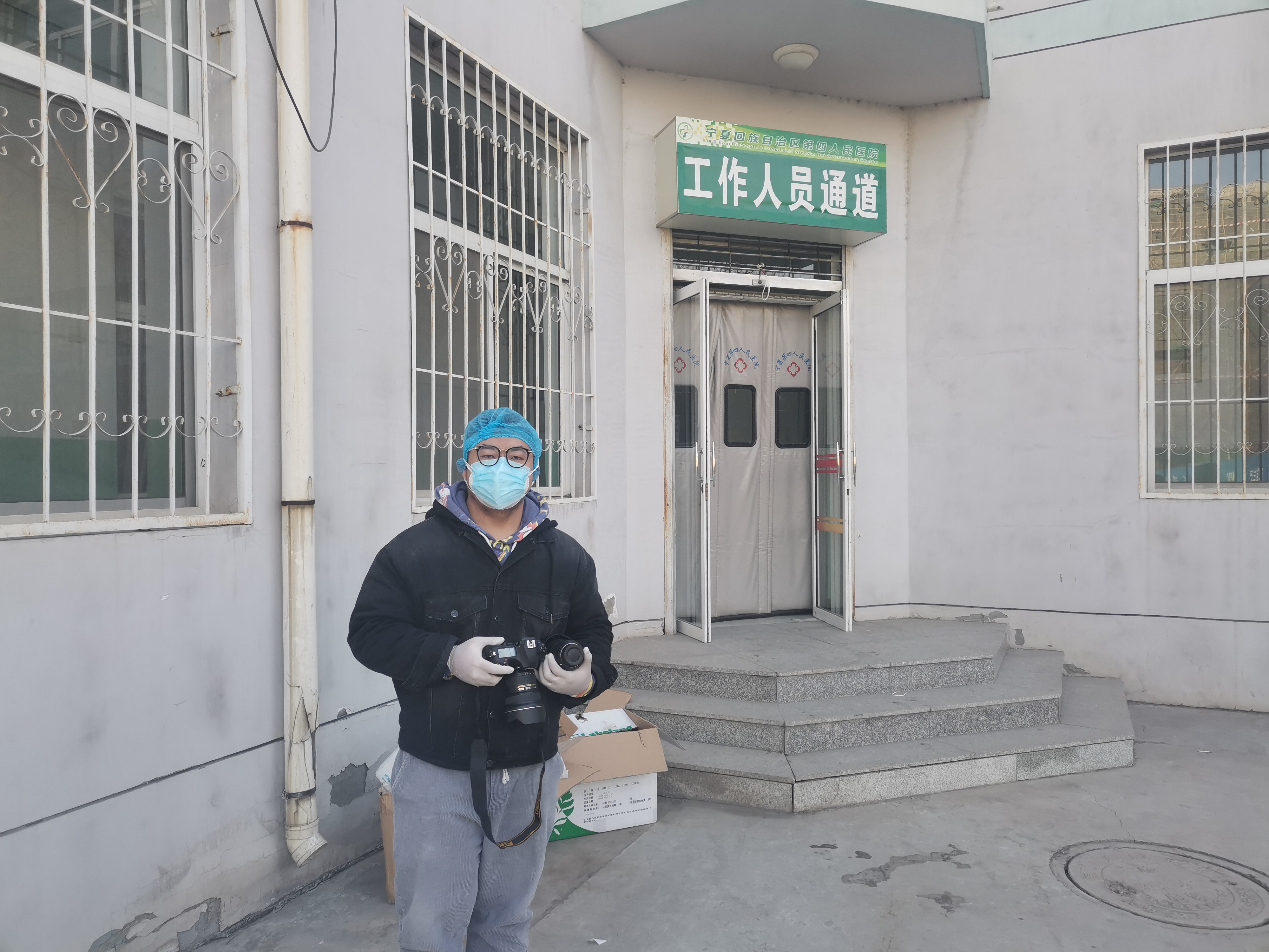 1月27日，寧報集團(tuán)馬楠在自治區(qū)第四人民醫(yī)院隔離病區(qū)樓門前全副武裝，準(zhǔn)備從工作人員通道進(jìn)入該樓的清潔區(qū)采訪。.jpg